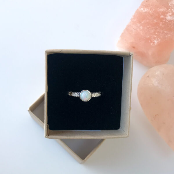 Round white opal ring in box