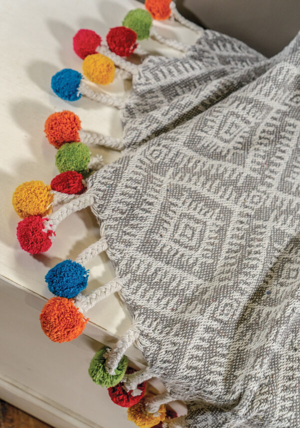 Rainbow pom pomo tassle Indian ethical sustainable throw Wildwood Cornwall